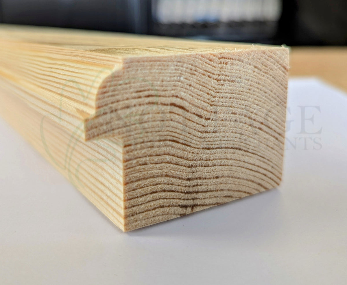 Close-up of a timber sash window upper section profile showing machined detail
