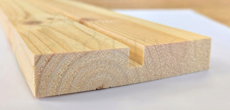 Timber pulley style component for traditional sash windows, showing grooved profile