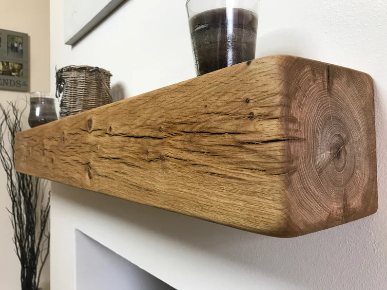 Solid rustic oak fireplace mantel shelf showing natural knots and grain, planed smooth finish